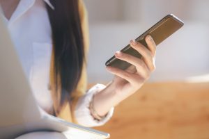 Young woman using tablet. Using online connections in technology to generate quality backlinks to drive website traffic, improve visibility, and increase SERP rankings.